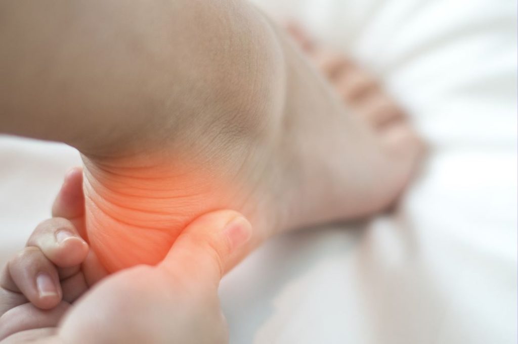 Heel Pain in Singapore. A photo showing a person suffering from pain at the heel. Understand the causes and treatment of heel pain.