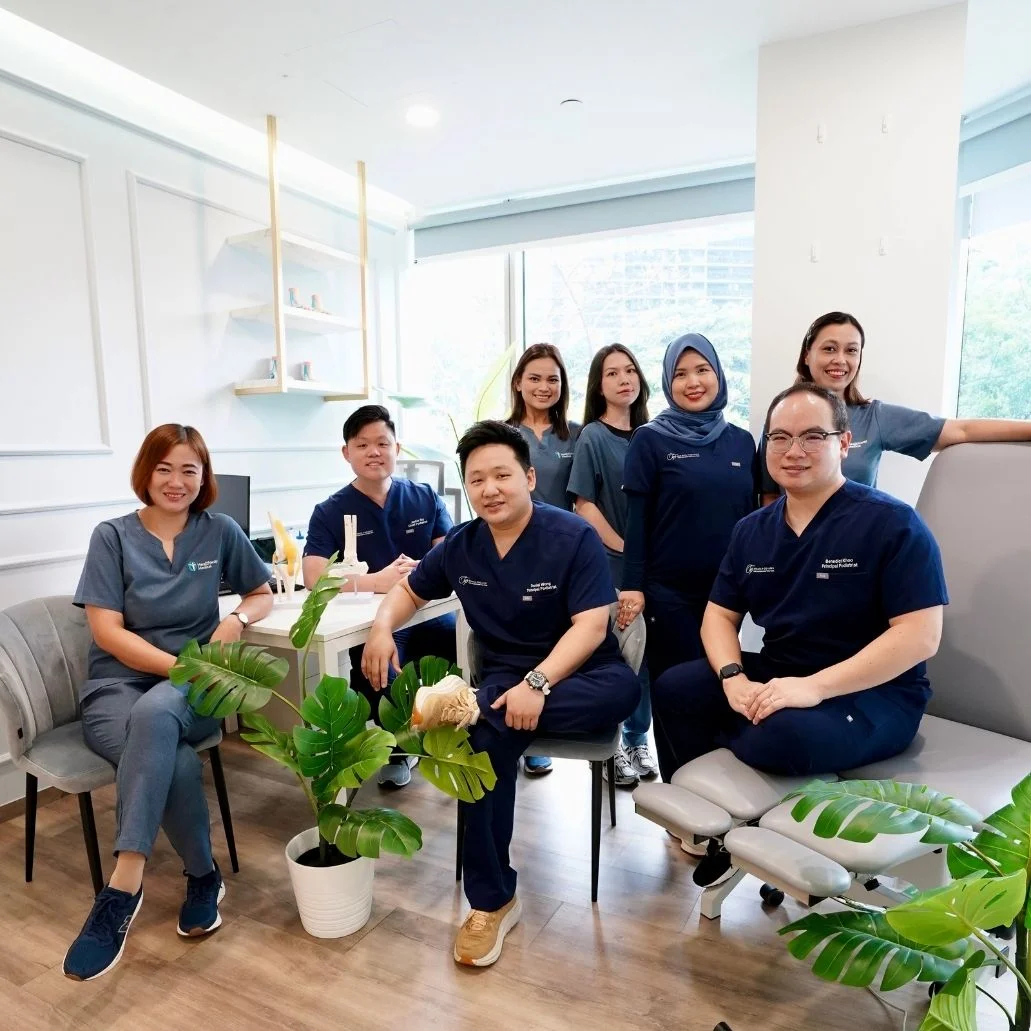 Team photo consisting podiatrists and staff of Straits Podiatry Singapore